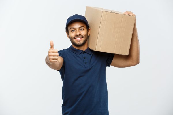 delivery-concept-portrait-happy-african-american-delivery-man-pointing-hand-present-box-package-isolated-grey-studio-background-copy-space-scaled.jpg